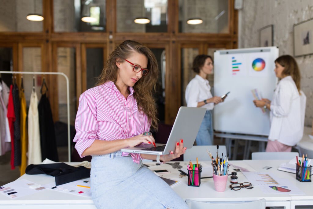 Young stylish woman in striped shirt and denim skirt and eyeglas